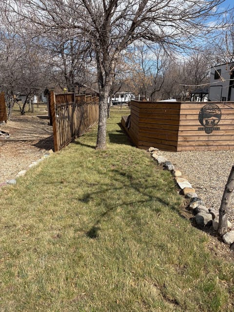 Freshly raked lawn along a cedar fence on a seasonal lot at Saskatchewan Landing